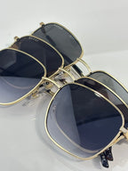 Gucci square sunglasses set with gold frames and dark lenses, overlapping fronts