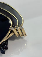 Gucci sunglasses hinge area with gold frame and temple end caps