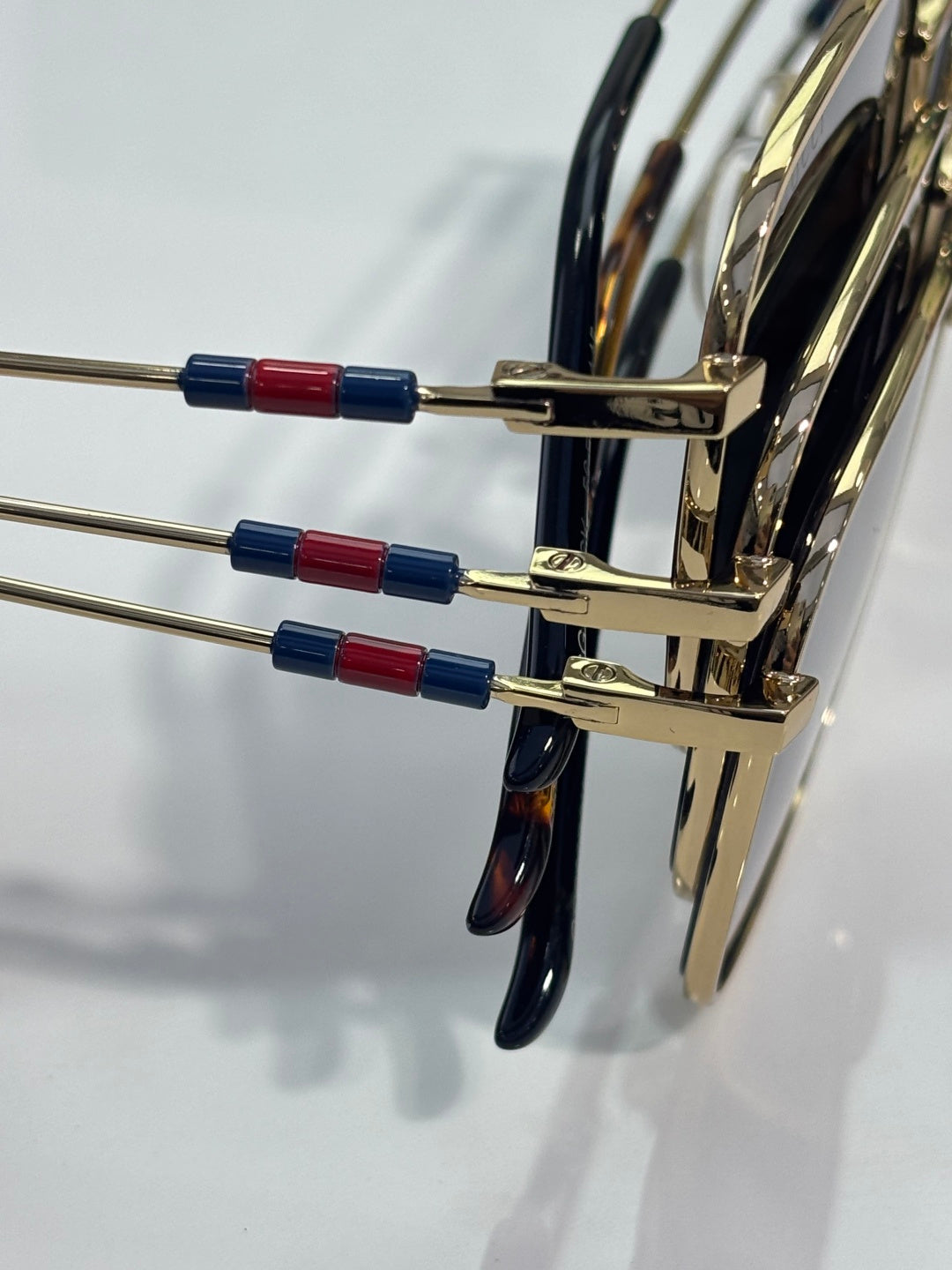 Gucci sunglasses temple arms with gold metal and red/blue enamel details