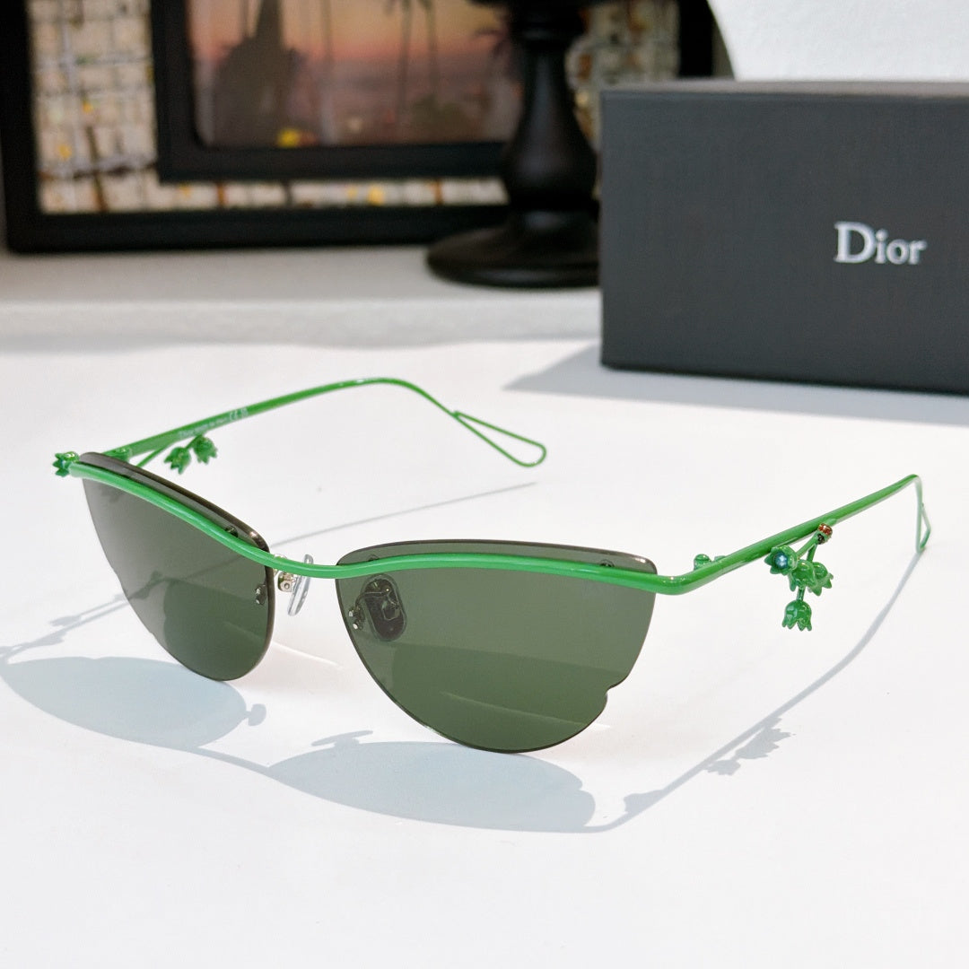 Dior sunglasses with green frame, green tinted lenses, and small floral charms