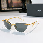 Dior sunglasses with gold frame, dark tinted lenses, and floral charm accents