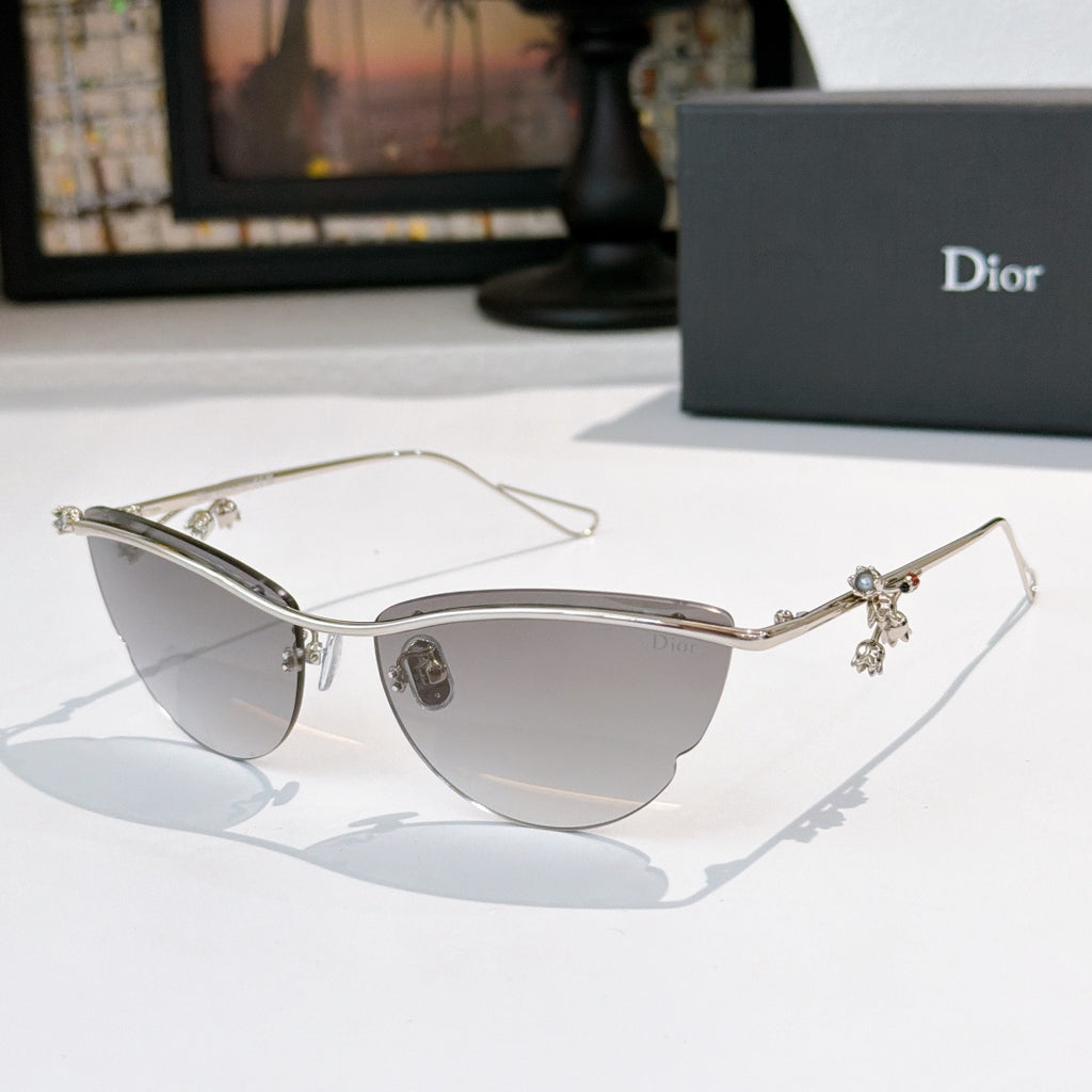 Dior sunglasses with silver frame, lightly tinted lenses, and floral charm details