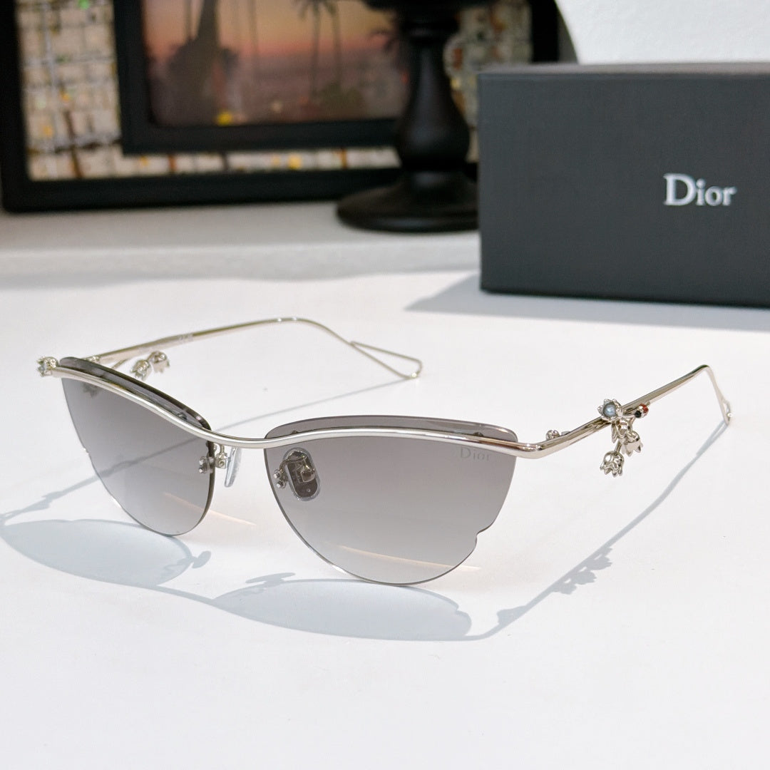 Dior sunglasses with silver frame, lightly tinted lenses, and floral charm details