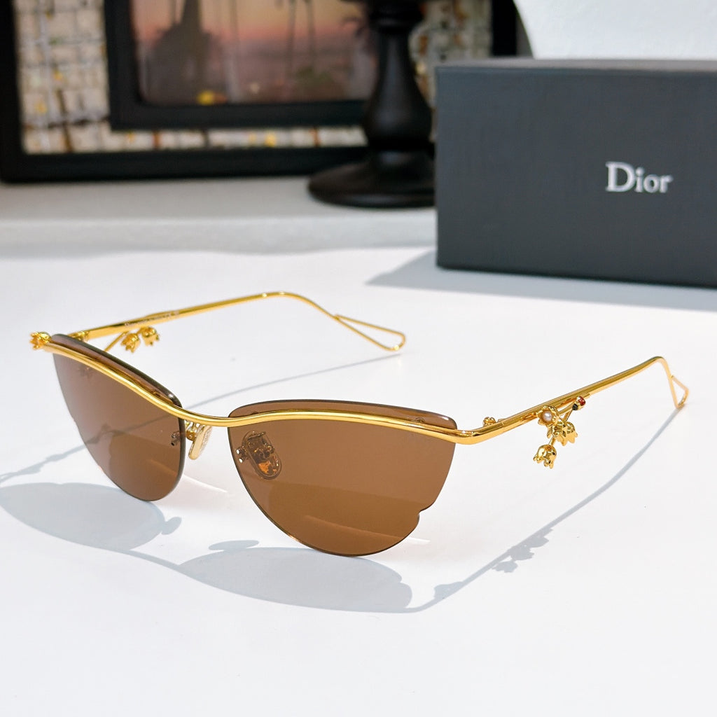 Dior sunglasses with gold frame, brown tinted lenses, and small floral charms