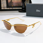 Dior sunglasses with gold frame, brown tinted lenses, and small floral charms