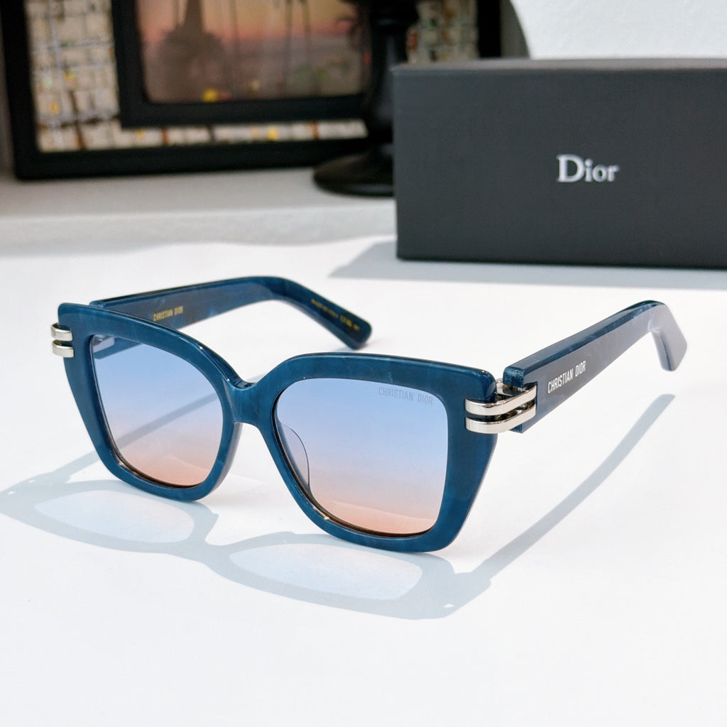 Dior sunglasses with teal frames and blue-tinted lenses, gold metal hinges.