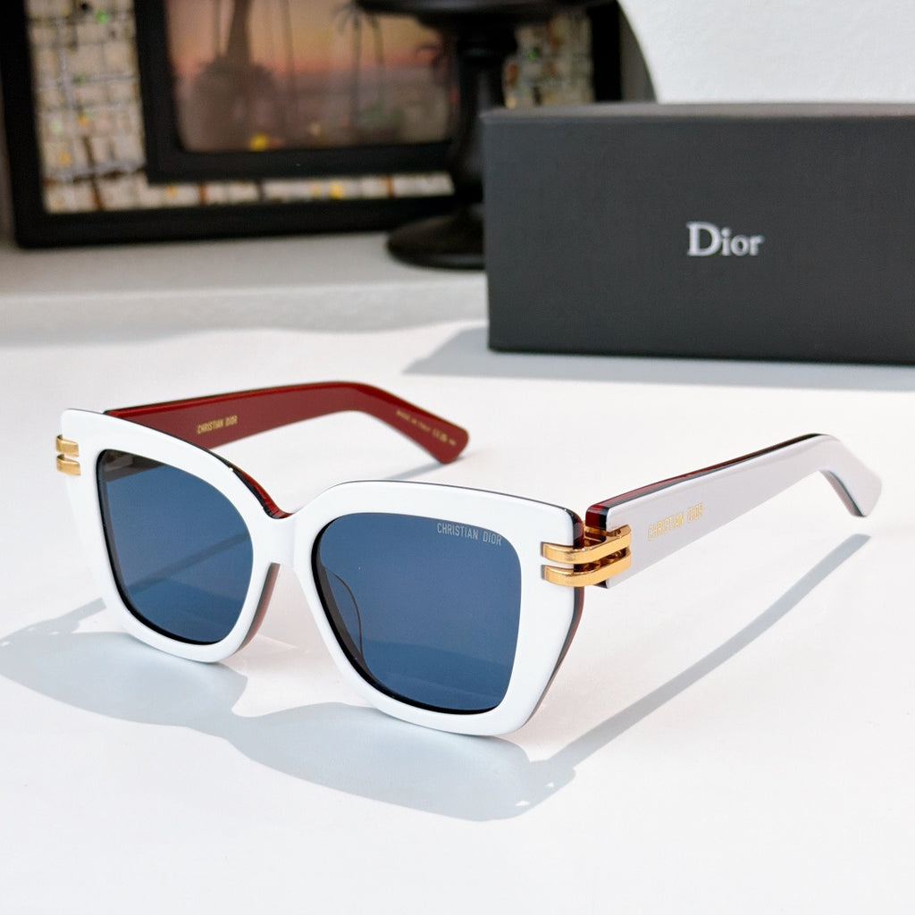 Dior sunglasses with white frames, red temples, blue lenses, gold metal accents.