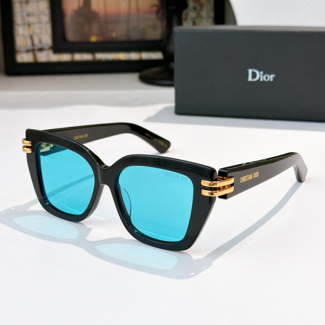 Dior sunglasses with black frames and turquoise lenses, gold metal accents.
