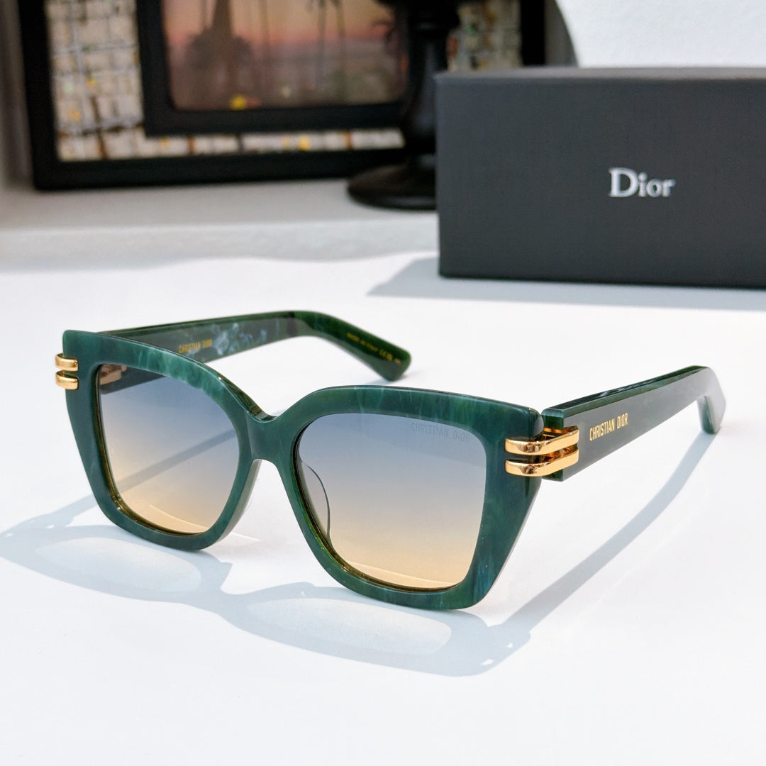 Dior sunglasses with green frames and tinted lenses, gold metal hinges.