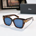 Dior sunglasses with tortoiseshell frames and blue lenses, gold metal hinges.