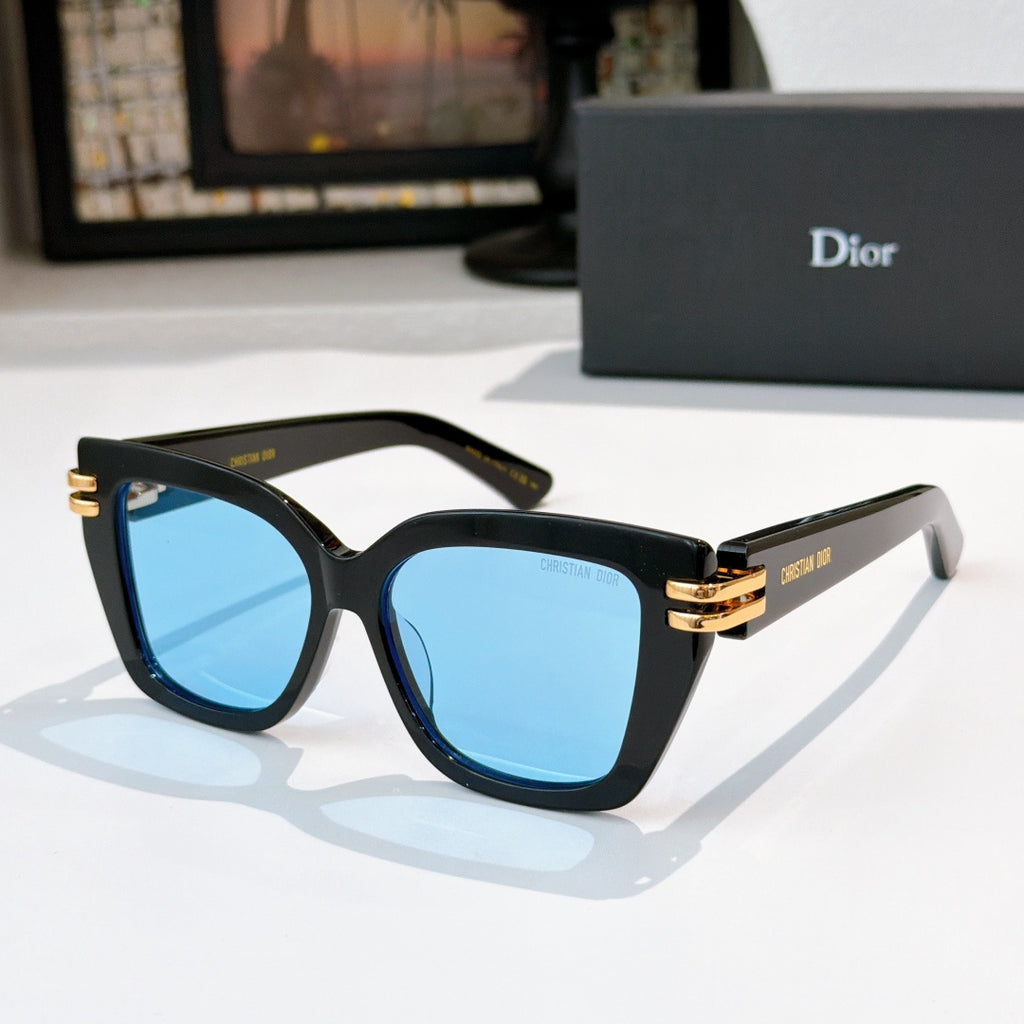 Dior sunglasses with black frames and blue lenses, gold metal hinges.