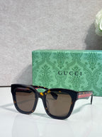 Gucci dark square sunglasses with tinted lenses and glossy black frame