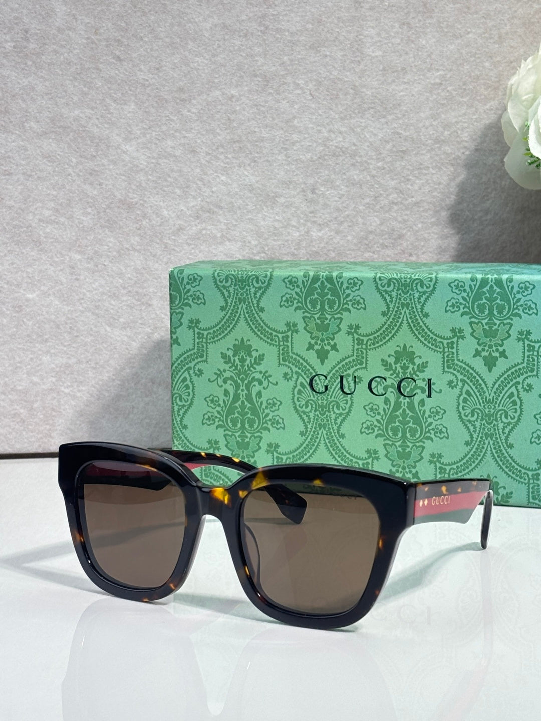 Gucci dark square sunglasses with tinted lenses and glossy black frame
