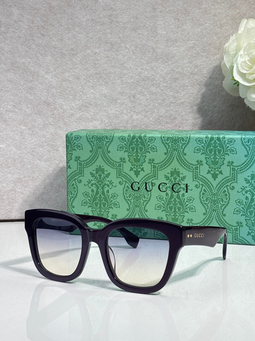 Gucci dark square sunglasses with light-tinted lenses and black temples