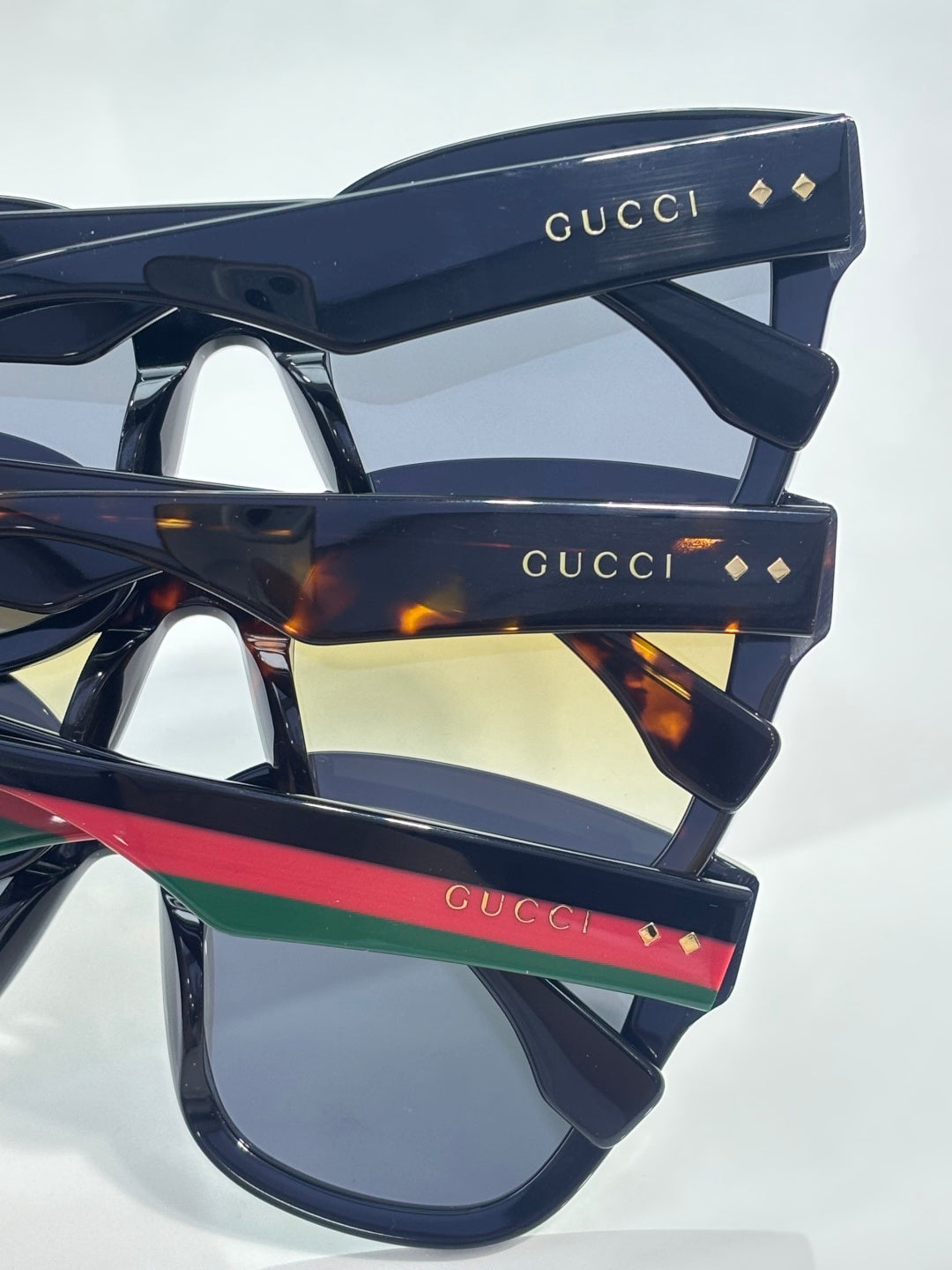 Gucci sunglasses temple arms with Gucci logo and multicolor stripe accents