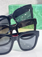 Gucci square sunglasses with dark lenses, shown in close-up