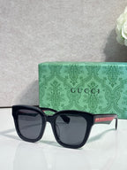 Gucci dark square sunglasses with dark lenses and green inner temple details