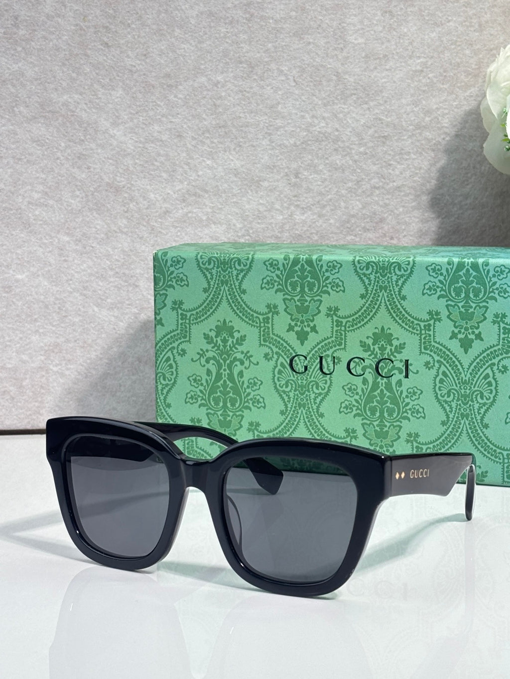 Gucci dark square sunglasses with pale lenses and green inner temple details