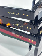 Gucci sunglasses temple arms with colored stripes and gold “Gucci” logo