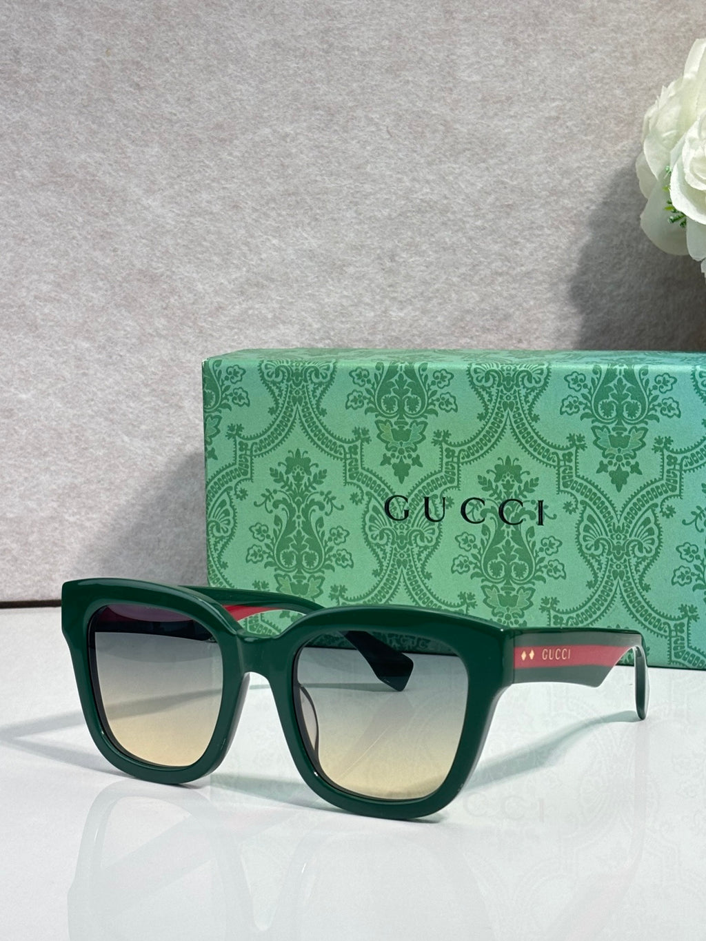 Gucci dark square sunglasses with green temples and tinted lenses