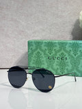 Gucci sunglasses with dark round lenses, black frame, gold-tone arms