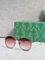 Sunglasses with pink mirrored round lenses, rose-tone frame, gold-tone arms