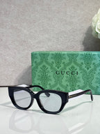 Gucci eyeglasses with dark navy frame and clear lenses, rounded rectangular shape