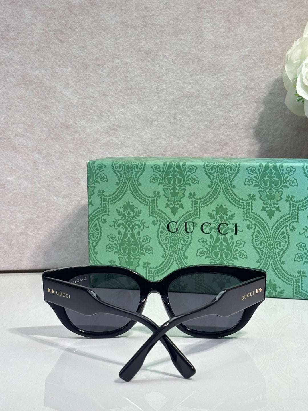 Gucci eyeglasses with dark navy frame and tinted lenses, oversized butterfly shape