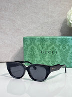 Gucci eyeglasses with dark navy frame and dark tinted lenses, rounded rectangular shape