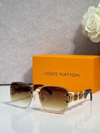 Sunglasses with warm brown gradient lenses and rose-gold frame; gold logo temple detail.
