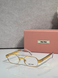 Gold eyeglasses with clear lenses and light pink temple arms, metal frame with logo plate