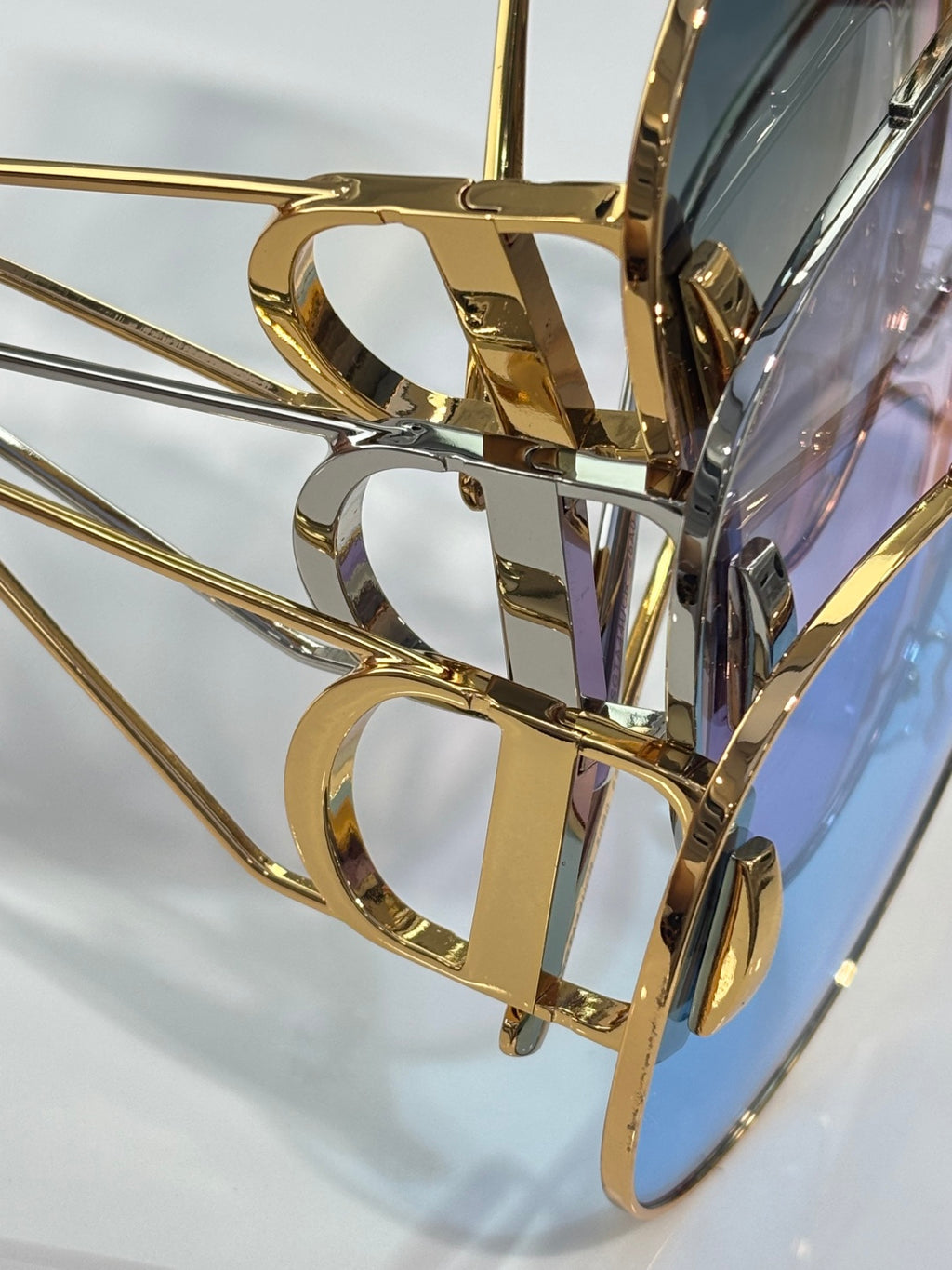 Dior sunglasses close-up of gold-tone metal frame and temple details