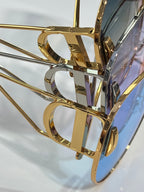 Dior sunglasses close-up of gold-tone metal frame and temple details