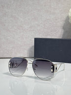 Dior sunglasses with dark tinted lenses and silver-tone angular frames