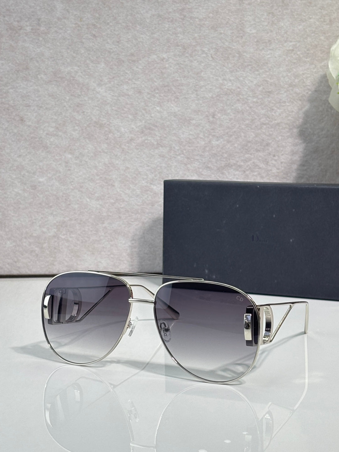 Dior sunglasses with dark tinted lenses and silver-tone angular frames