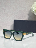 Dior eyeglasses with dark green frames and gold bar details, tinted gradient lenses