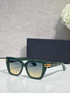 Dior eyeglasses with dark green frames and gold bar details, tinted gradient lenses