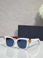 Dior eyeglasses with white frames, gold bar details, and dark blue tinted lenses