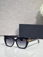 Dior eyeglasses with black frames and gold bar details, clear-tinted lenses