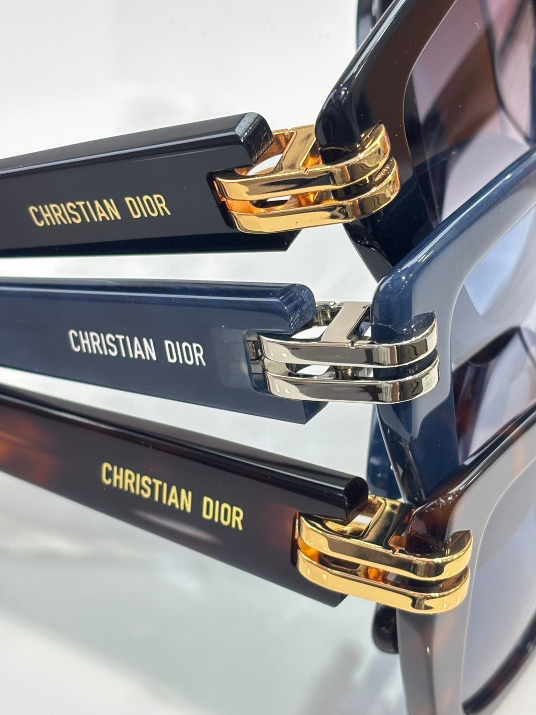 Dior eyeglasses temple close-up with Christian Dior text and gold hinges