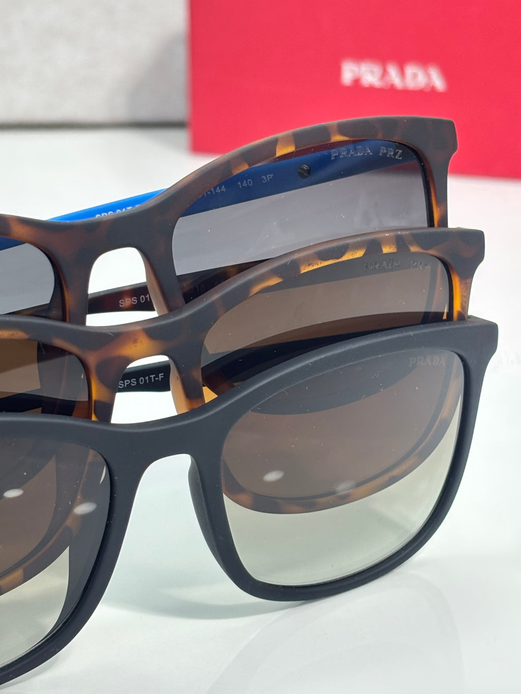 Prada sunglasses close-up with dark lenses and layered tortoiseshell frames
