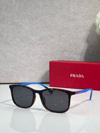 Prada sunglasses with dark lenses and tortoiseshell frames, with blue temple accents and case