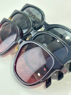 Assorted navy and burgundy sunglasses with gold accents and tinted lenses