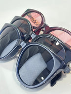 Gucci sunglasses group view with blue frames and tinted lenses, glossy finish