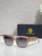 Versace sunglasses with tan acetate frame and dark lenses, gold “101” emblem on temple.