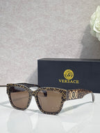 Versace sunglasses with leopard-print frame and brown-tinted lenses, gold “101” logo.