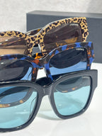 Versace sunglasses with leopard and blue frames, gold “101” logo on temples.