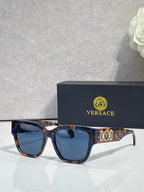 Versace sunglasses with tortoiseshell frame and dark blue lenses, gold “101” logo.