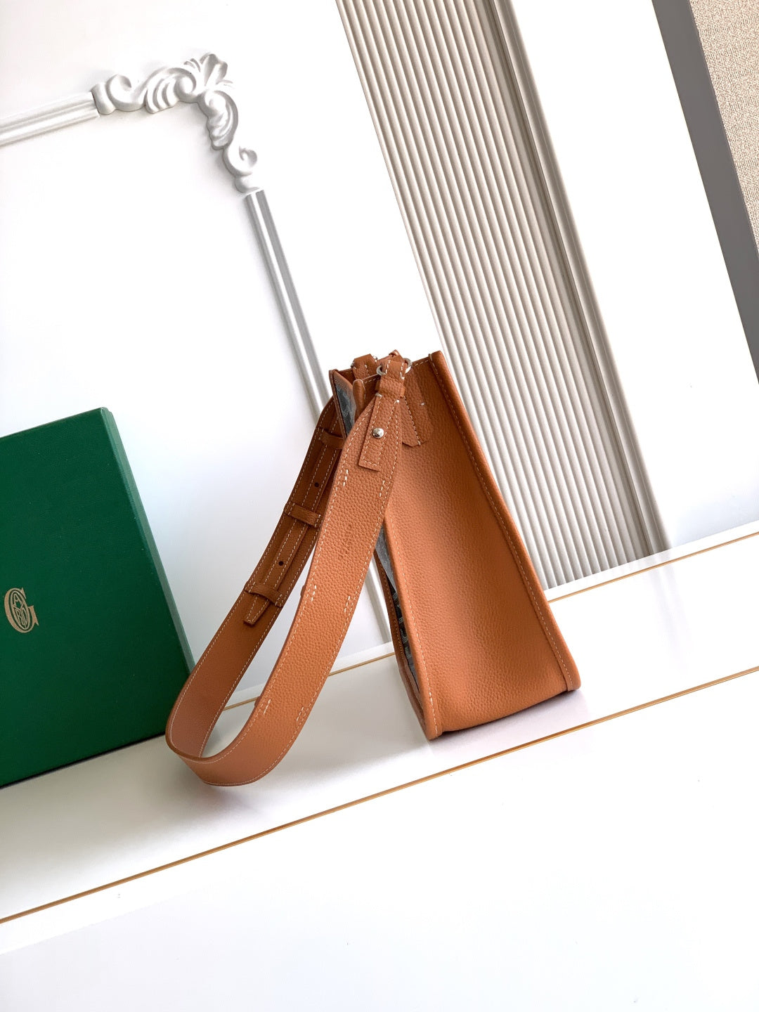 Leather bucket-style bag with shoulder strap in tan, top handles