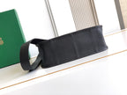 Black leather strap bag with wide strap and snap-closure front
